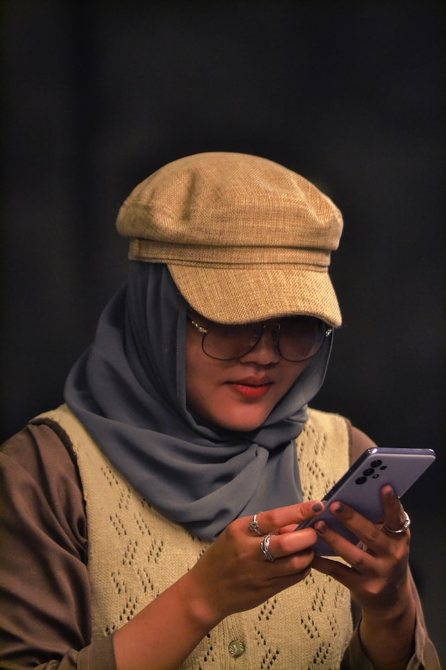 Women checking phone by designpik.net